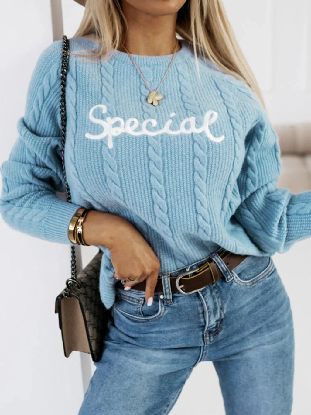 Blue crew neck knitwear pullover with embroidered letters and numbers text pattern