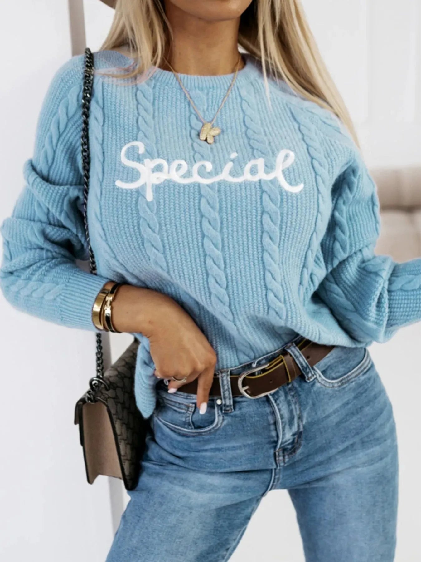 Blue crew neck knitwear pullover with embroidered letters and numbers text pattern