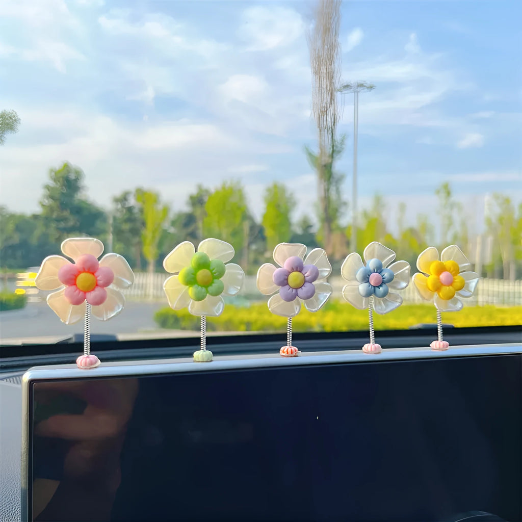 Small colourful plastic swing car decoration hanging ornament in blue, green, pink, purple, or yellow.