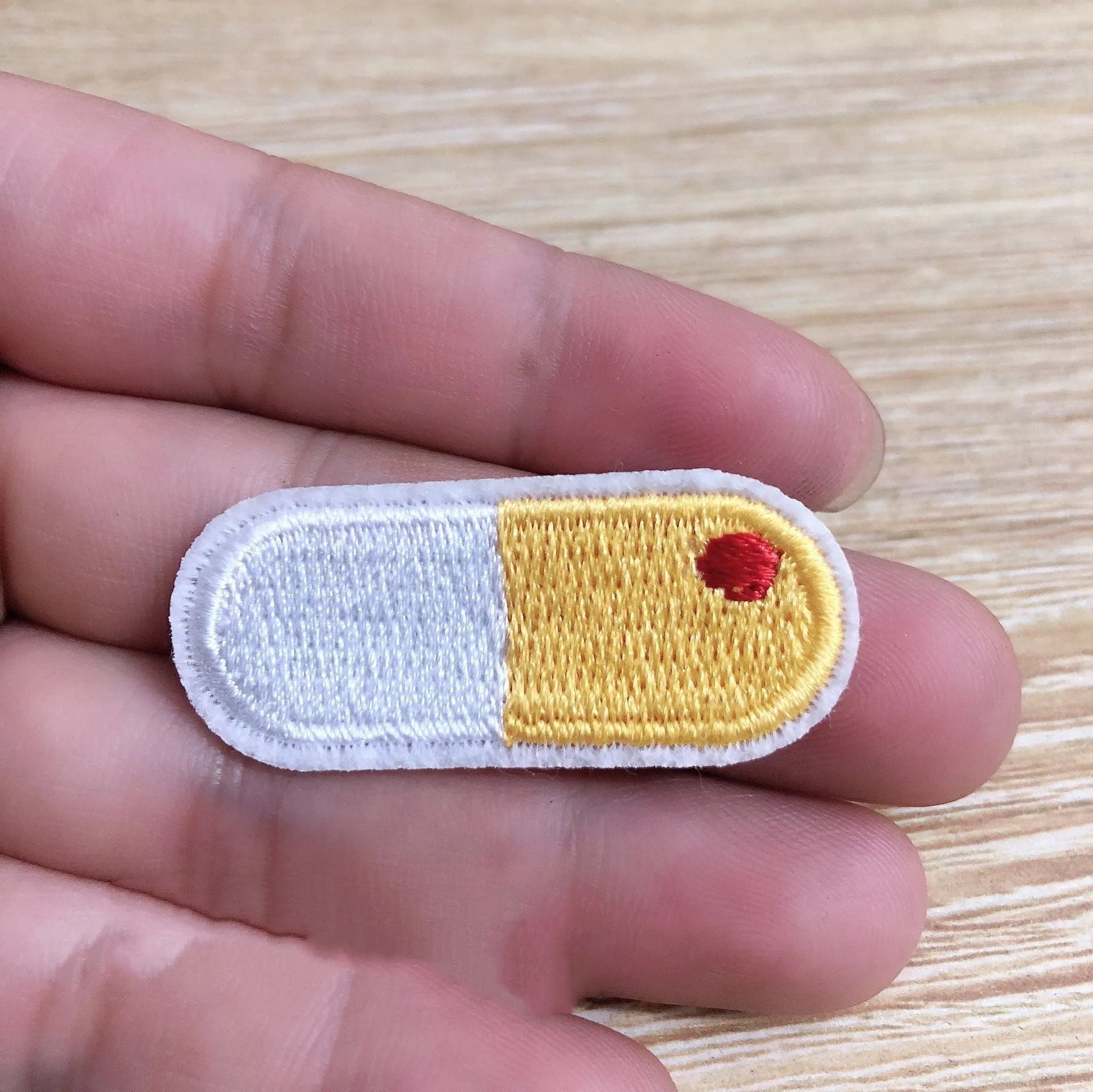 Pack of ten embroidered iron-on cloth patch badges for clothing and craft customisation.