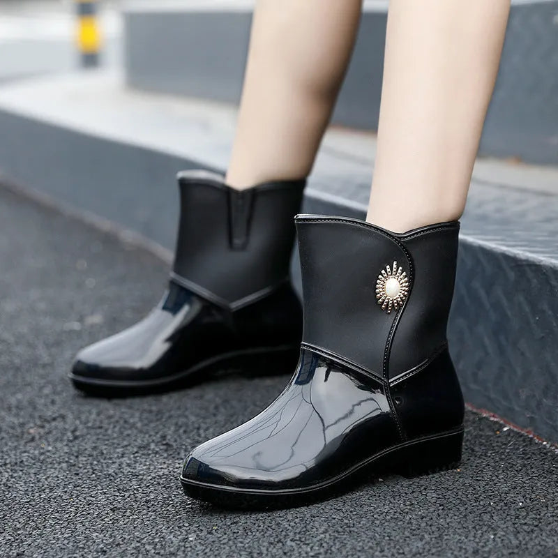 Women's mid-calf rain boot in purple PVC with a non-slip sole and low tube design.