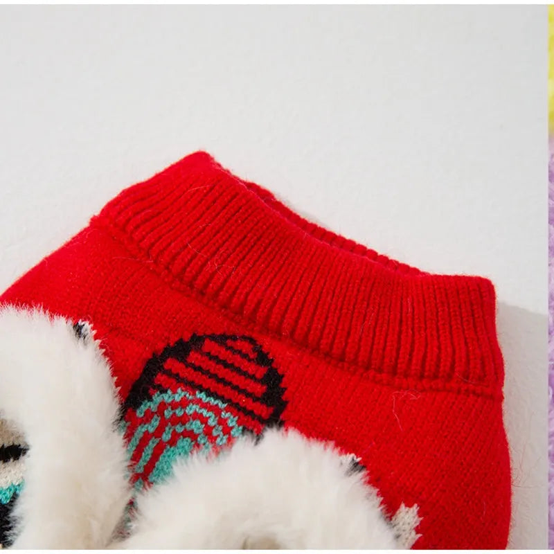 Red knitted lion dance pet sweater with 3D plush face details and colourful embroidery on a cat