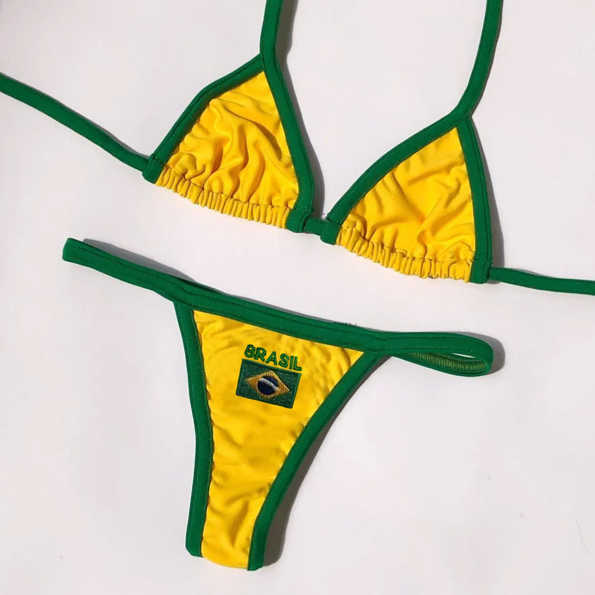 Women's yellow polyester bikini set with T-back bra and shorts-length bottoms on mannequin