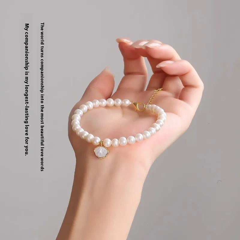 Women's freshwater pearl bracelet with fan-shaped design and alloy details.
