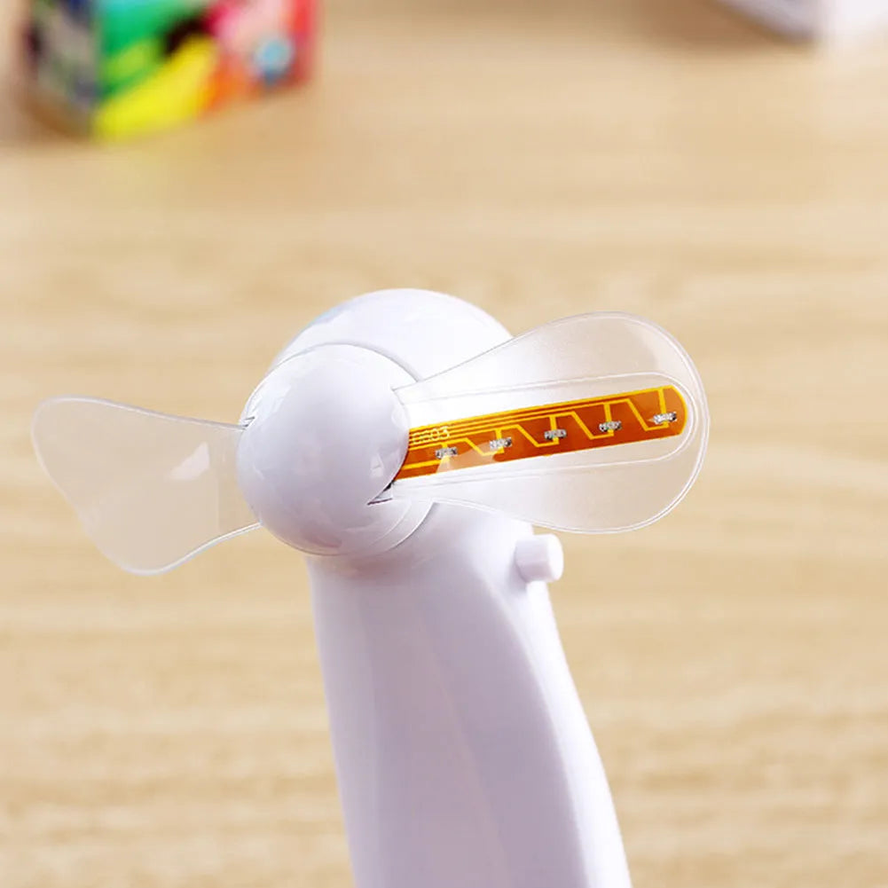 White handheld mini fan with LED lights displaying love pattern and I love you message