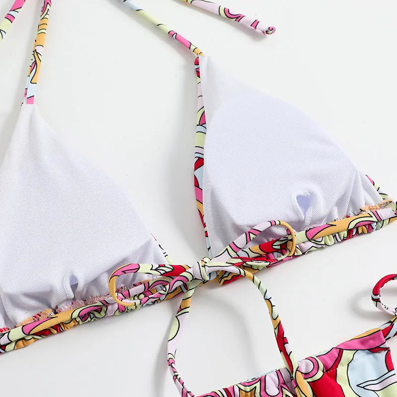 Multicolour printed women's triangle bikini set with hanging neck top and separate bottoms.