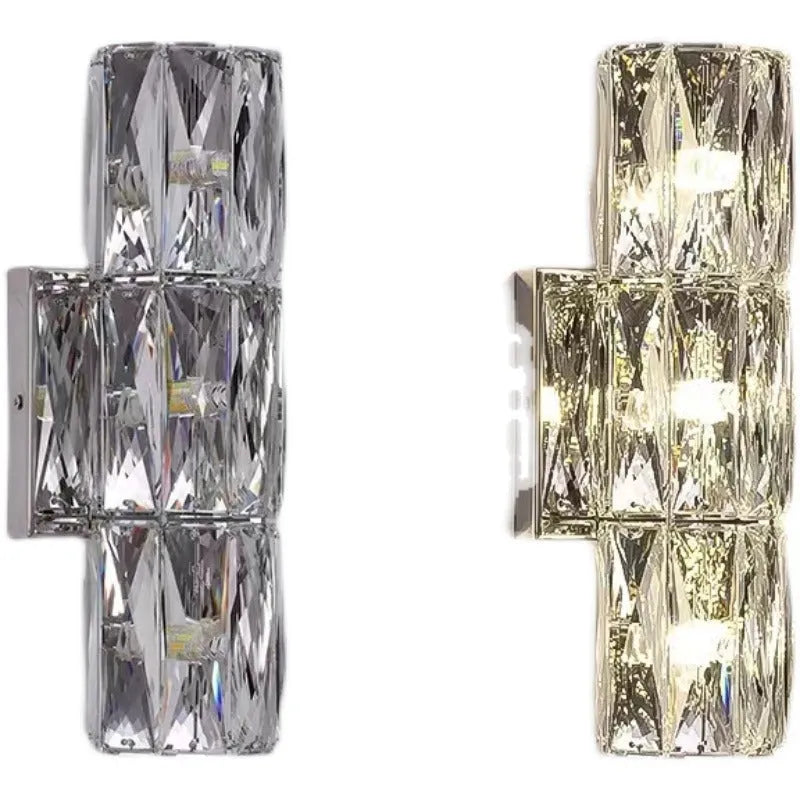 Slim crystal and stainless steel wall lamp with LED light on a wall.