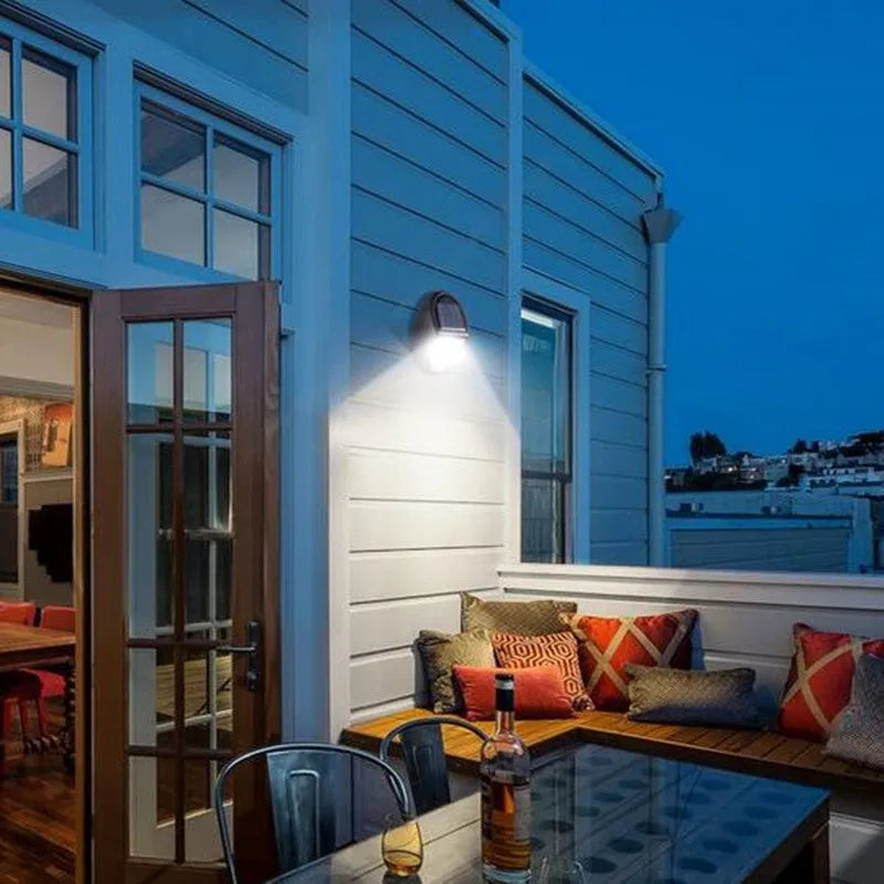 Black rectangular solar-powered LED wall light with automatic sensor for outdoor use.