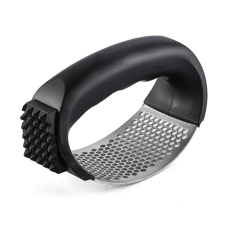 Stainless steel garlic press in green, showing compact 11cm design for crushing garlic.