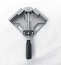 Black aluminium alloy 90 degree right angle clip with 70mm opening on a wooden workbench.