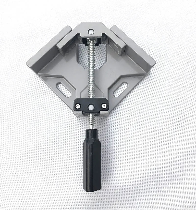 Black aluminium alloy 90 degree right angle clip with 70mm opening on a wooden workbench.