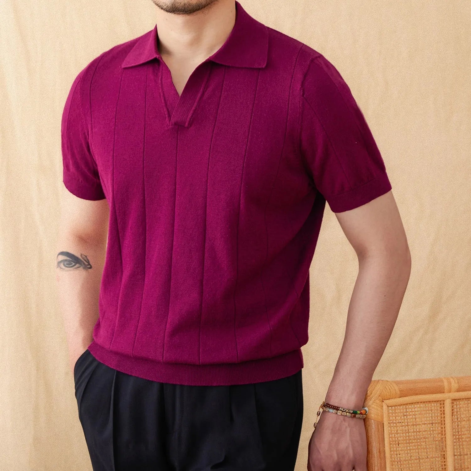 Man's purple short sleeve polo shirt with seagull collar and sunken stripe knitted texture.