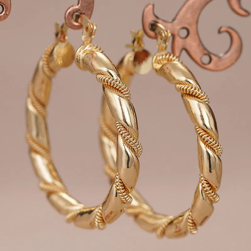 Geometric copper earrings with ring and line design in golden colour on ear