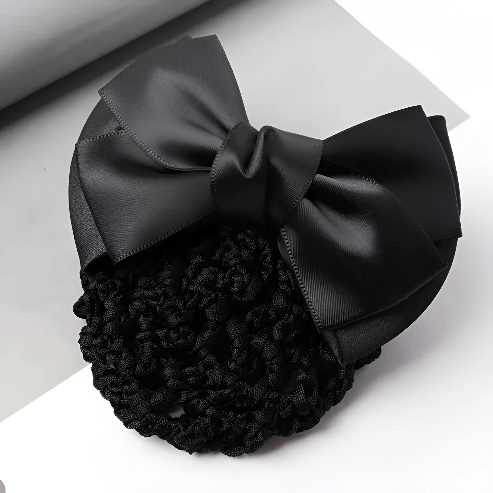 Professional flower bow headdress hair clip ornament on a work plate, shown in a selection of net and mesh colour variations.