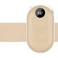 Compact rose gold USB rechargeable hand warmer and power bank with digital display on a wooden table.