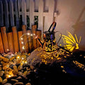 Iron solar garden lamp with tapered butterfly pattern and warm white LED lighting