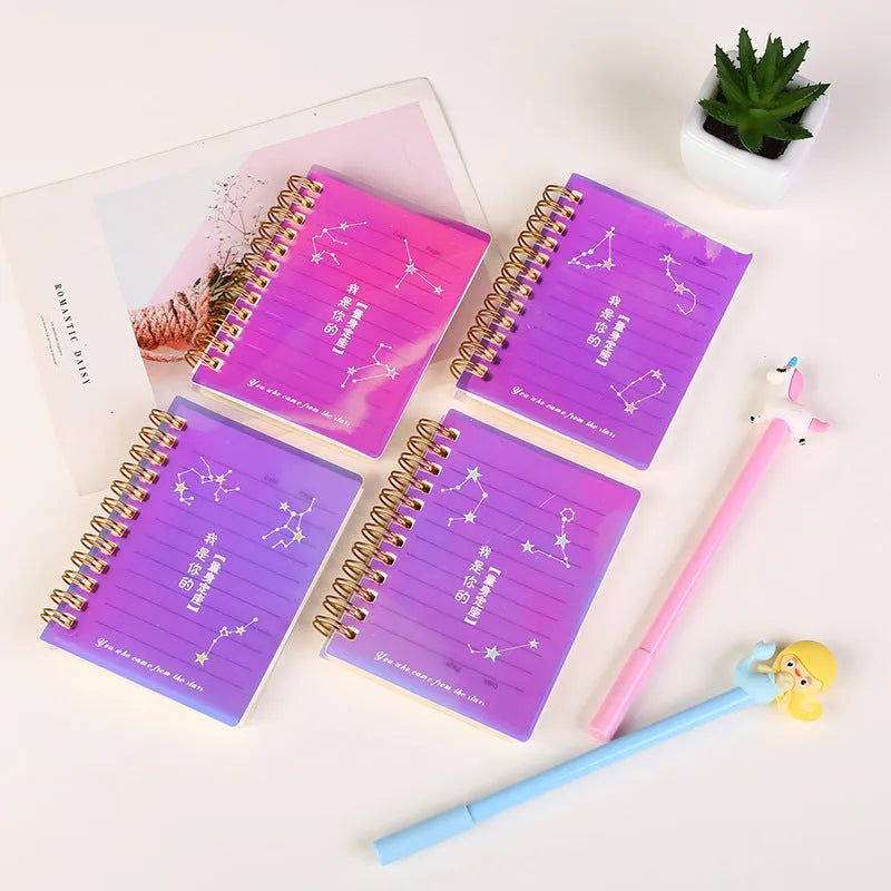 Set of four A7 spiral notebooks with different coloured PP plastic covers, showing spiral binding and open page.