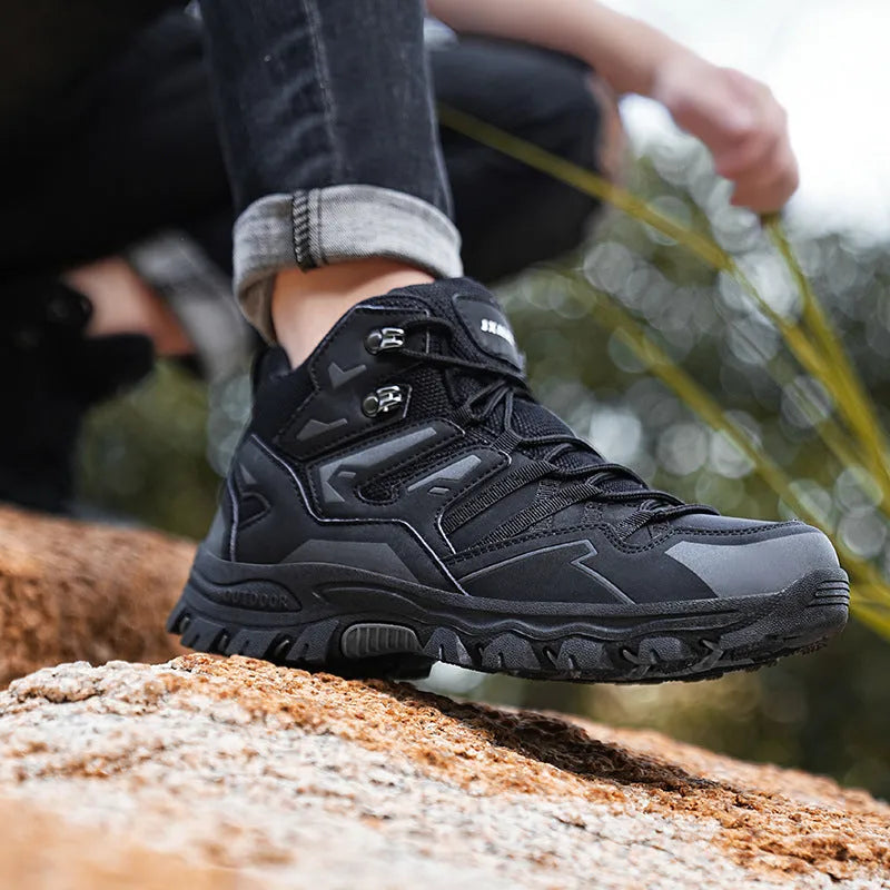 A pair of low-top hiking sneakers with a lace-up front, shown in a colour option like grey or purple.
