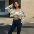 Striped long-sleeve women's pullover sweater in mercerised cotton showing exposed navel style.