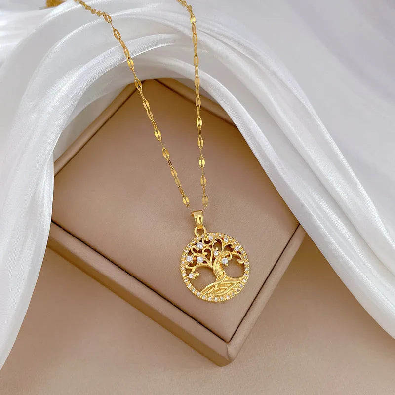 Gold plated Lucky Tree necklace with mother of pearl pendant and rhinestone zircon detail on a lip chain.