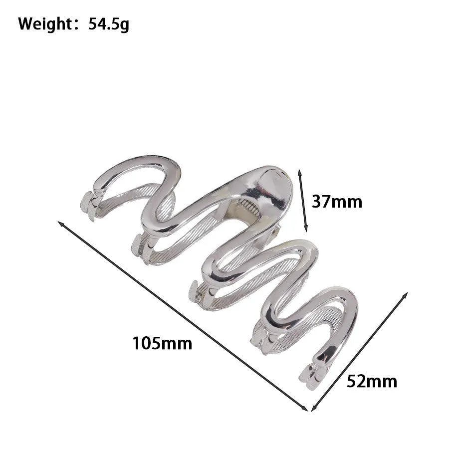 Assortment of silver metal hair claw barrettes with various designs including bows, pearls, and geometric shapes.