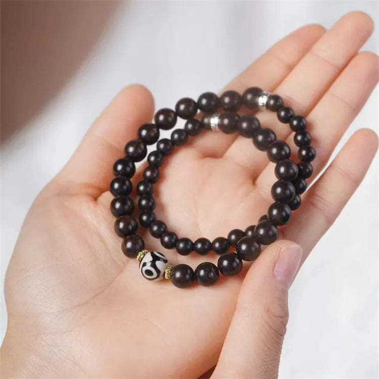 Ebony wood Tibetan bracelet with 8mm beads and two-circle pattern on wrist