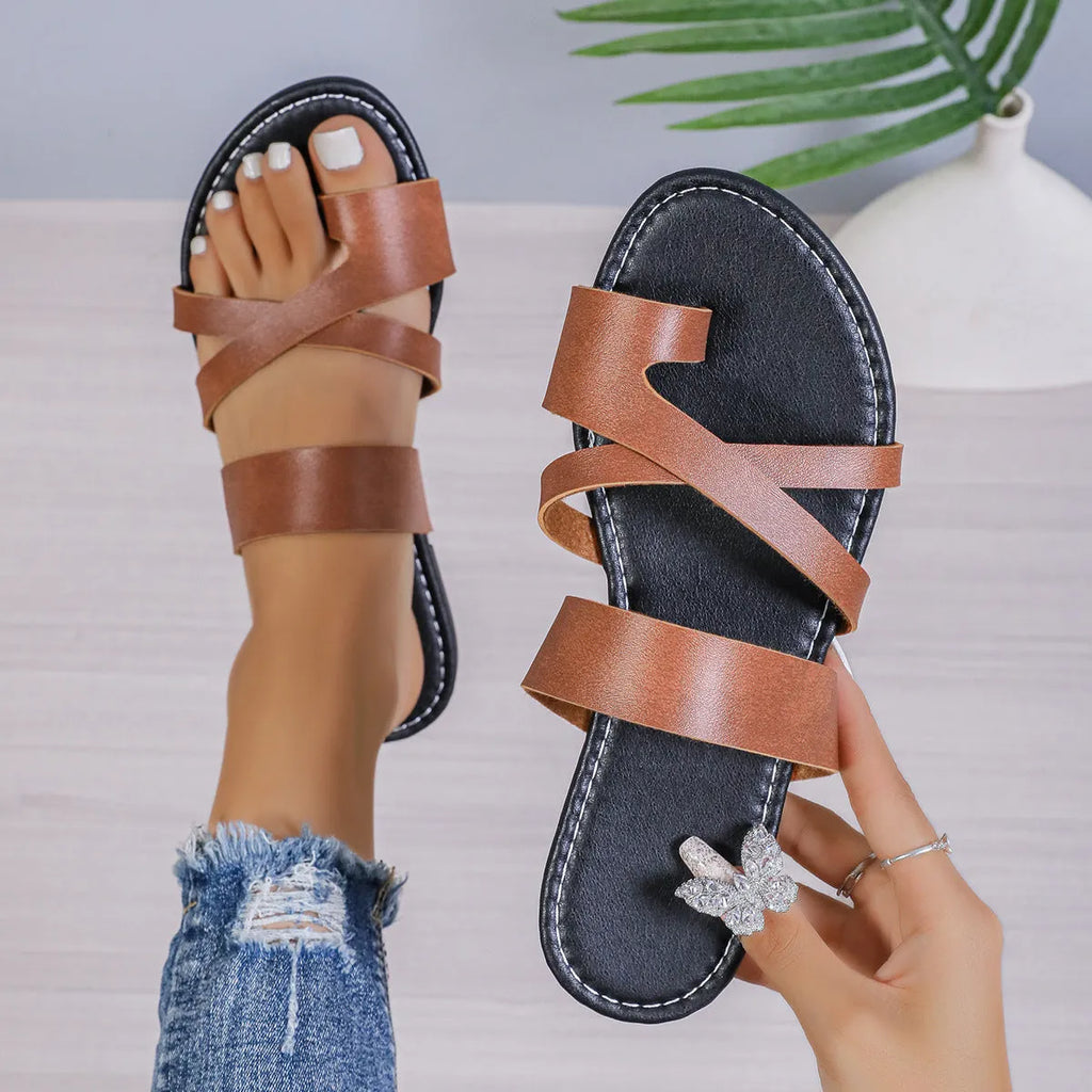 Adult round-head beach slippers in black with a one-line design, hollow-out pattern, and rubber sole.