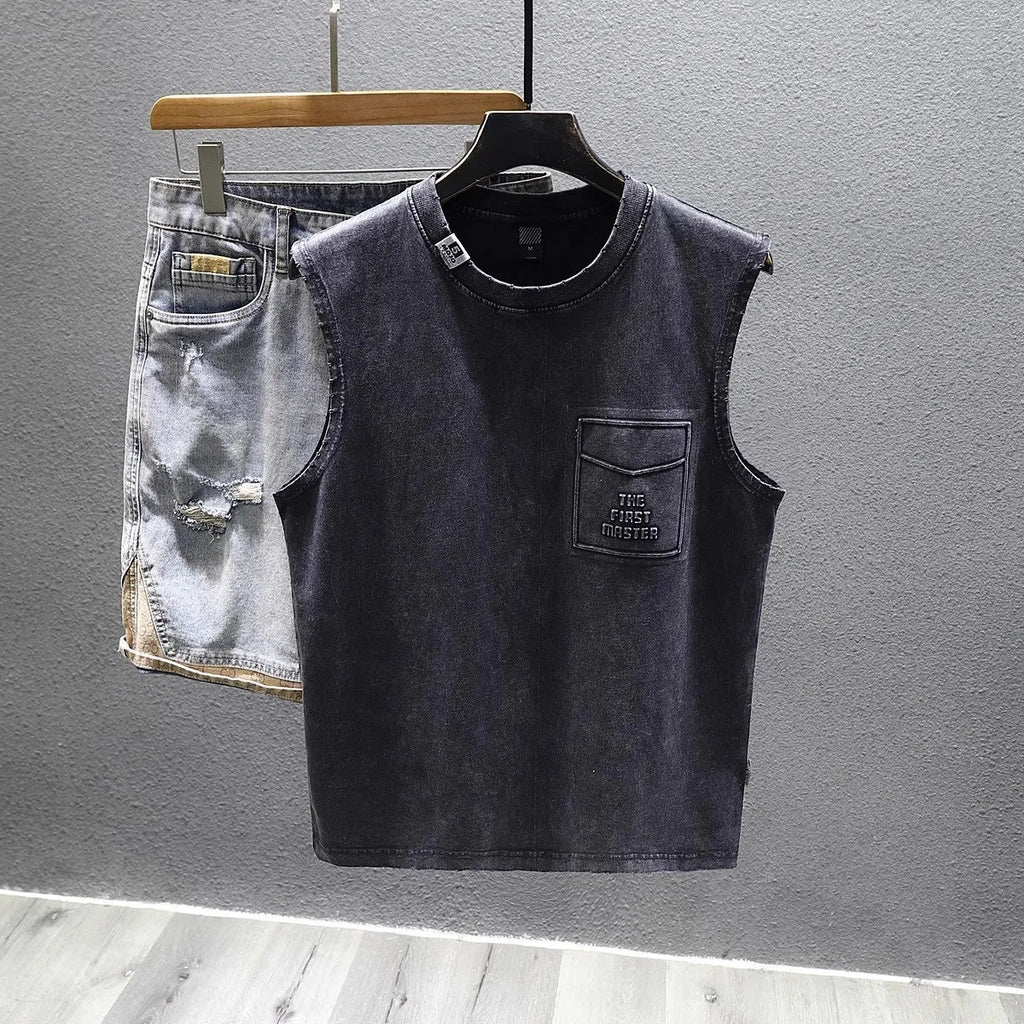 A black loose-fit cotton sleeveless t-shirt with a straight hem, laid flat.