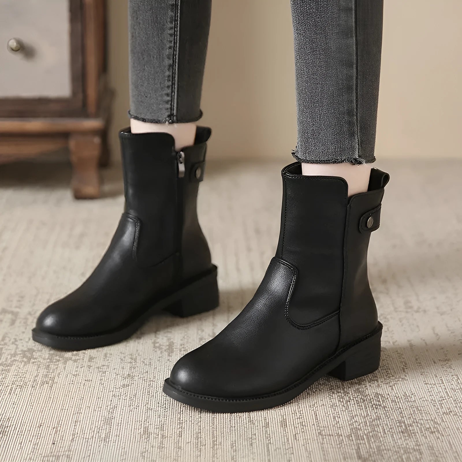 Black women's ankle boots with side zip and a low round toe.