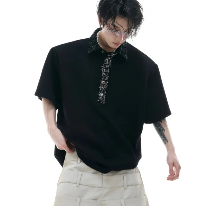 Men's black loose fit polo shirt with square collar and embroidery sequin details on sleeve.