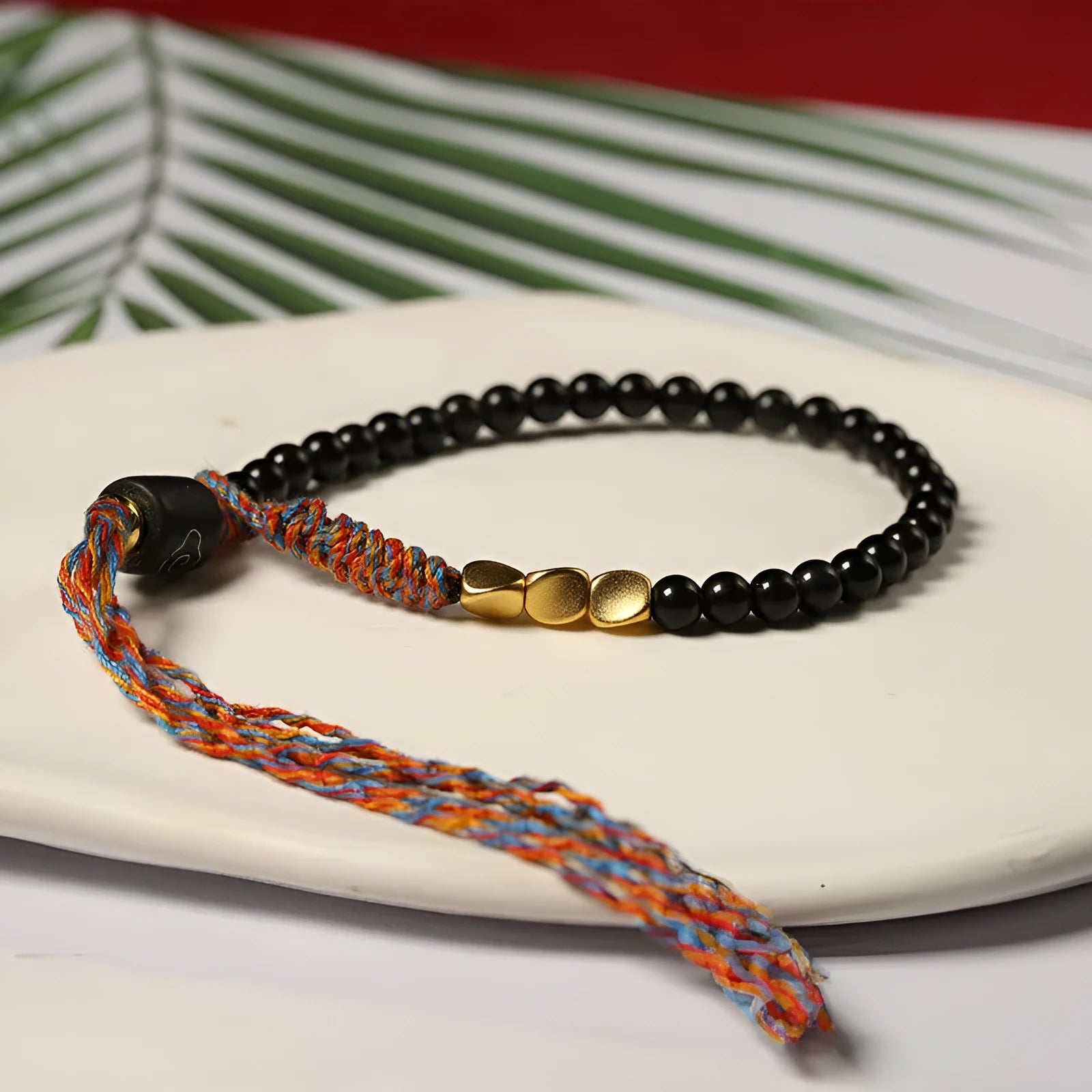 Hand-woven obsidian carrying strap showing texture and 4mm width