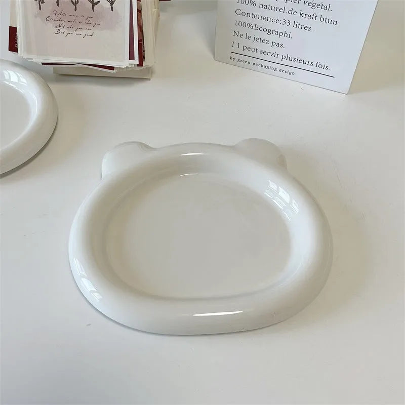 White ceramic chubby toot plate with doodle design, shown in bear and round styles.