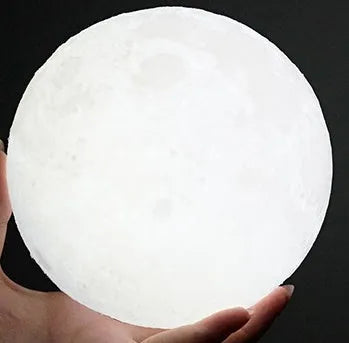 3D printed spherical moon lamp on a wooden stand with touch ring control