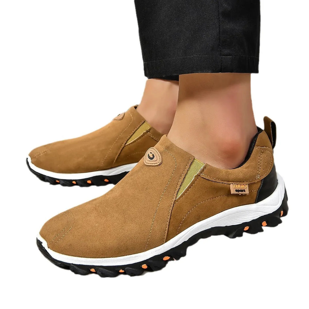 Men's grey slip-on shoe cover with round toe and rubber sole on a white background.