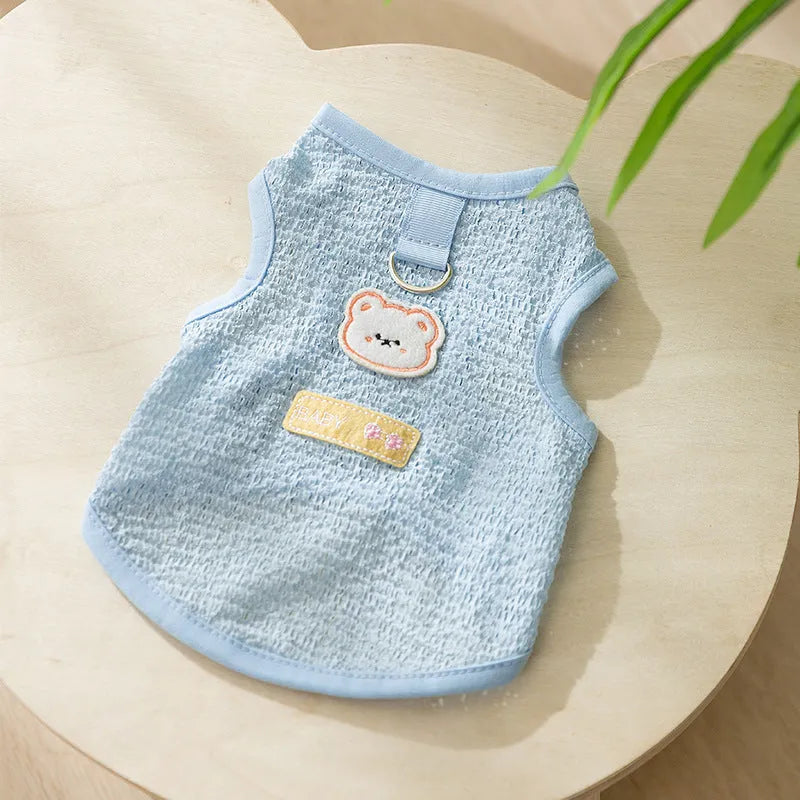 Green knitted cat clothing with a bear patch, showing hollowed-out breathable knit fabric.