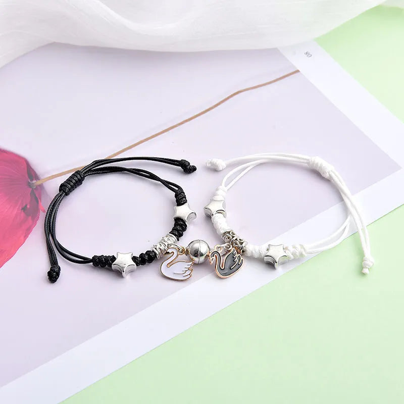 Pair of alloy suction bracelets with engraved symbol choices including crown, love lock, and clover.