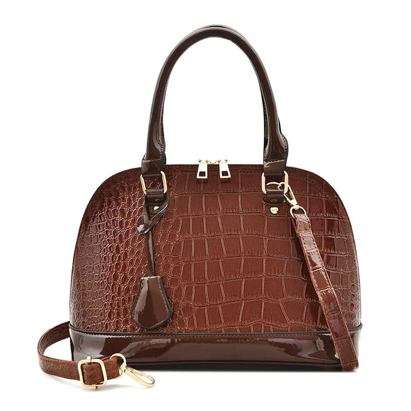 Shiny black PU leather shell-shaped crossbody bag showing its structured design and size.