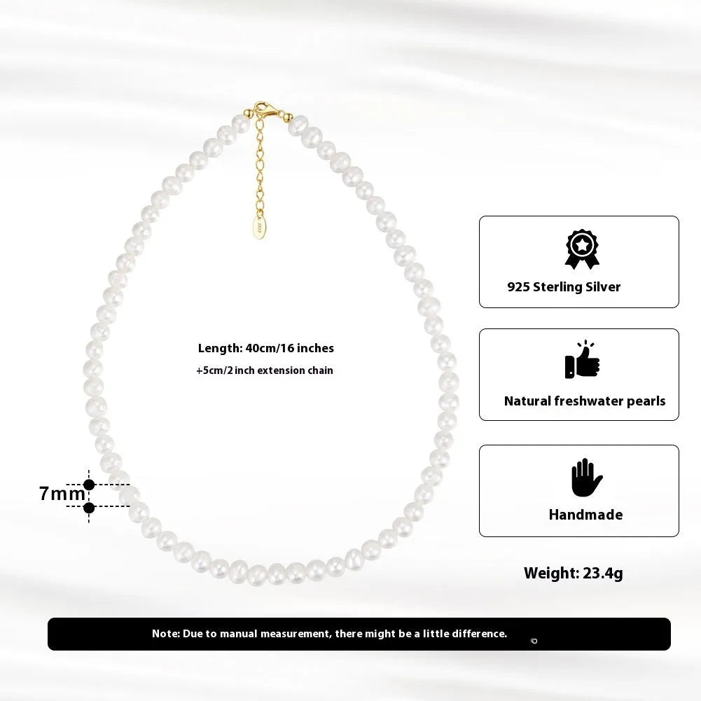 Close-up of a women's adjustable necklace with a round natural freshwater pearl on a silver chain.