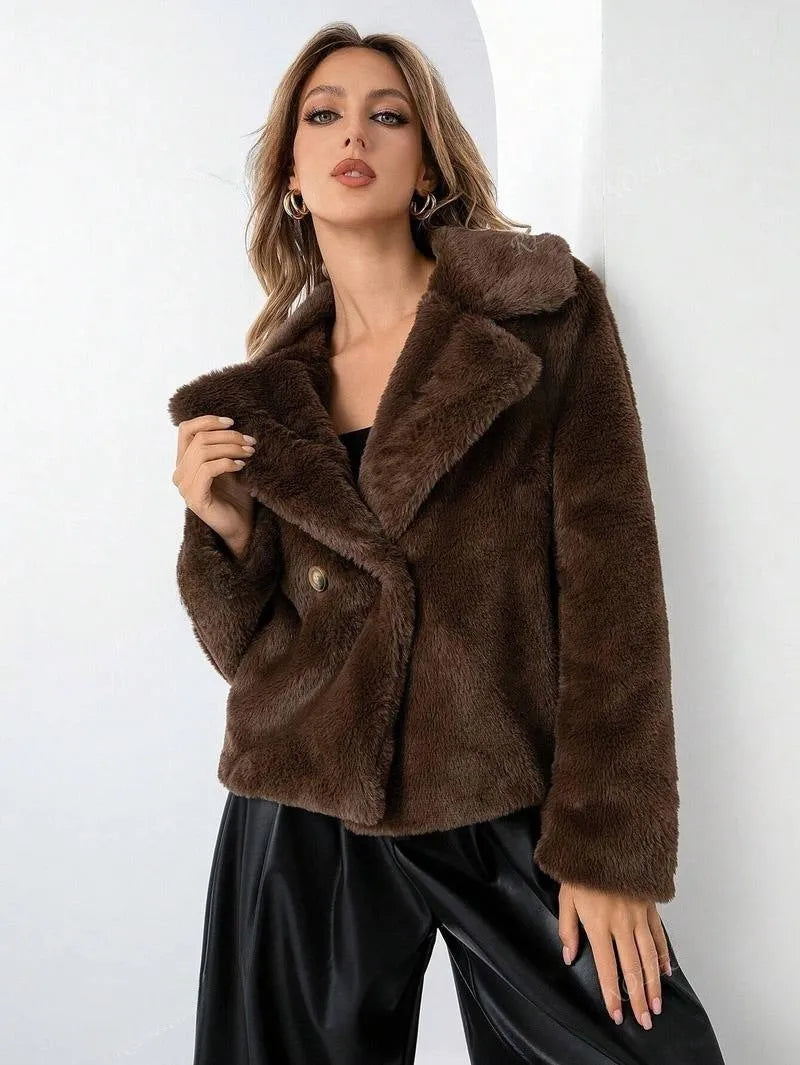 Loose short women's coat in rose red faux fur with regular sleeves on a hanger.