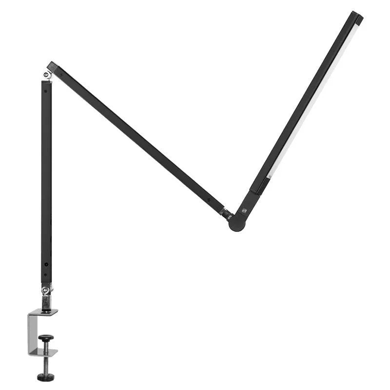 Black adjustable clip-on desk lamp with flexible arm and remote control on a wooden desk