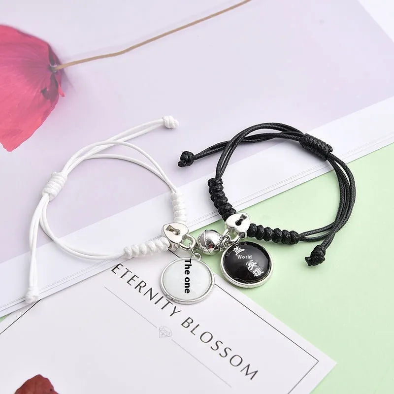 Pair of alloy suction bracelets with engraved symbol choices including crown, love lock, and clover.