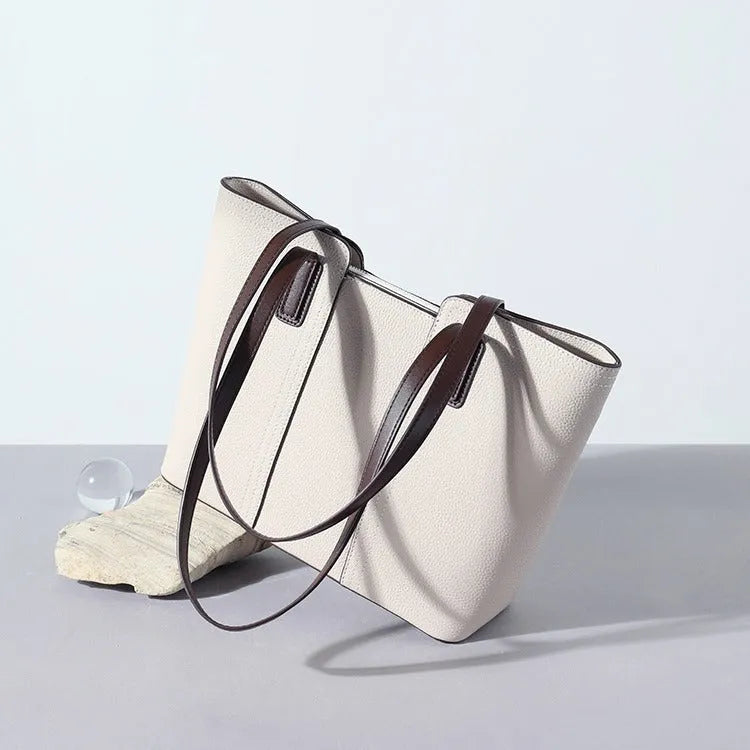 Women's genuine leather large capacity shoulder bag in khaki colour with visible sewing lines and a structured box shape.