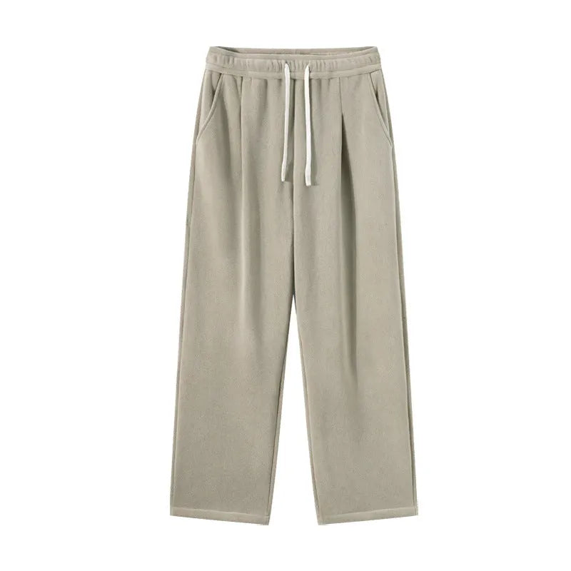 Men's thick apricot coloured fleece-lined loose fit casual sports trousers on a hanger.
