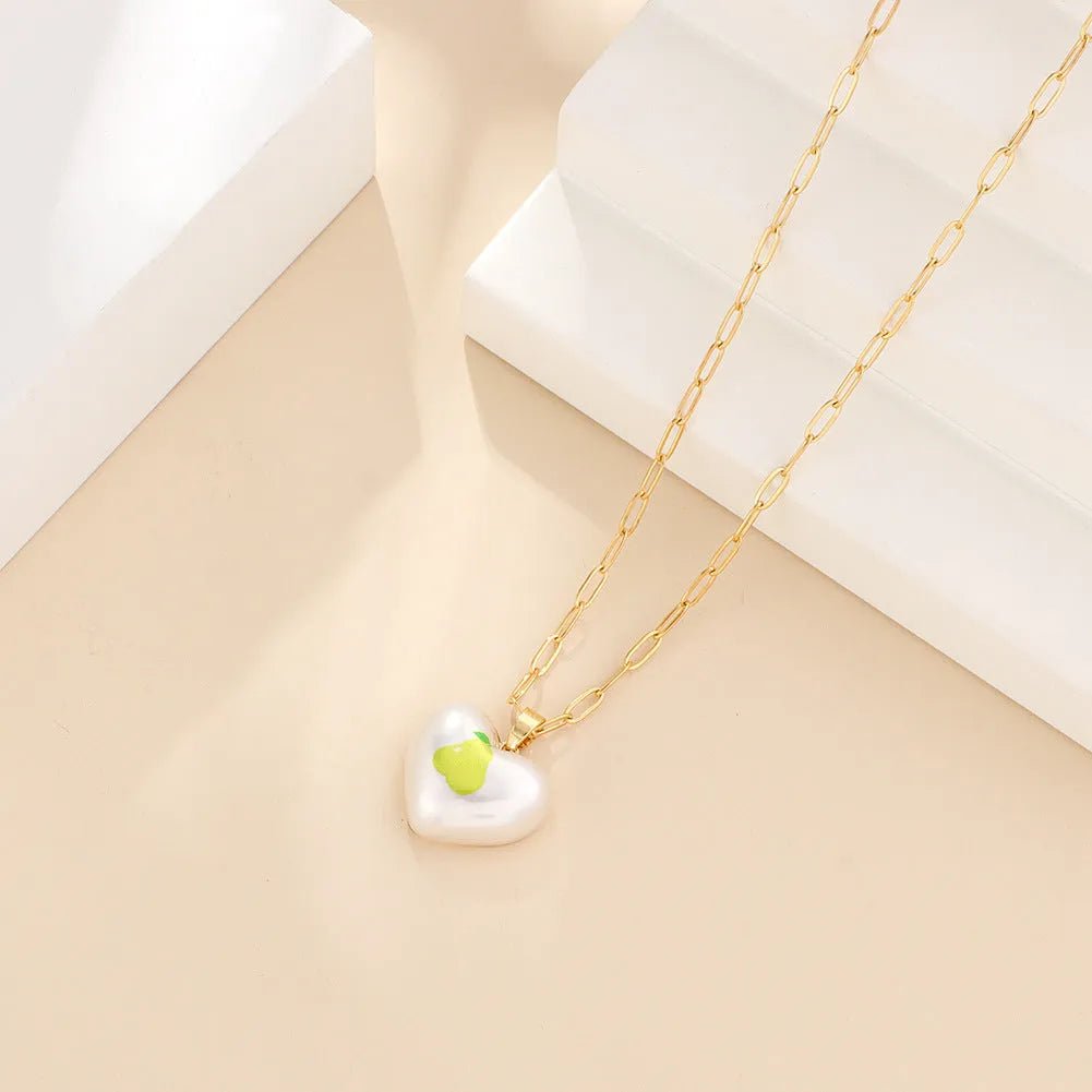 Heart-shaped necklace with a choice of fruit pendant charms on an adjustable chain.