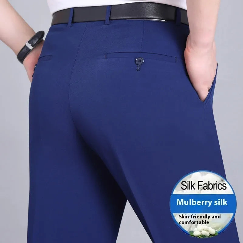 Man wearing black straight-leg high-waisted non-iron business trousers made from a Mulberry Silk blend fabric.