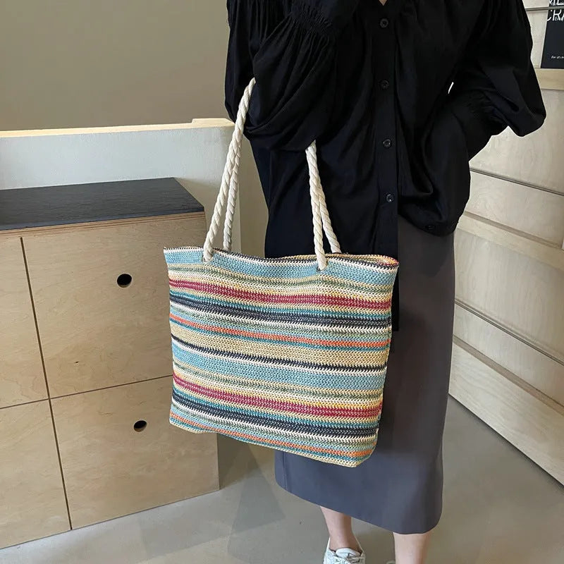 Blue woven straw shoulder bag with traditional weaving patterns and single shoulder strap