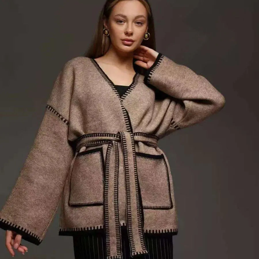 Loose fit knitted cardigan sweater coat in camel colour, showing long sleeves and mid-length hem.