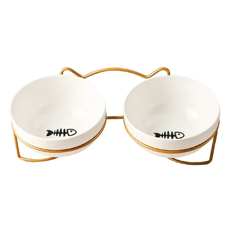 White ceramic pet bowl with cat paw design on a black metal stand with cat ear details.