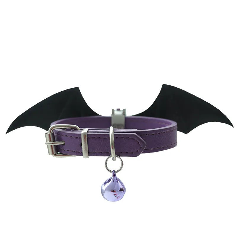 Small leather dog collar with decorative devil wings and bell in patent leather satin