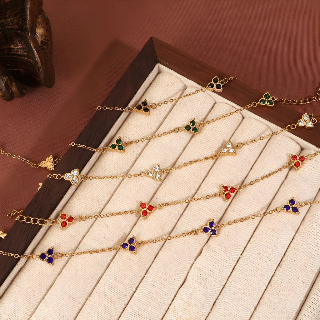 Women's stainless steel bracelet with three triangular charms set with coloured zircon stones.